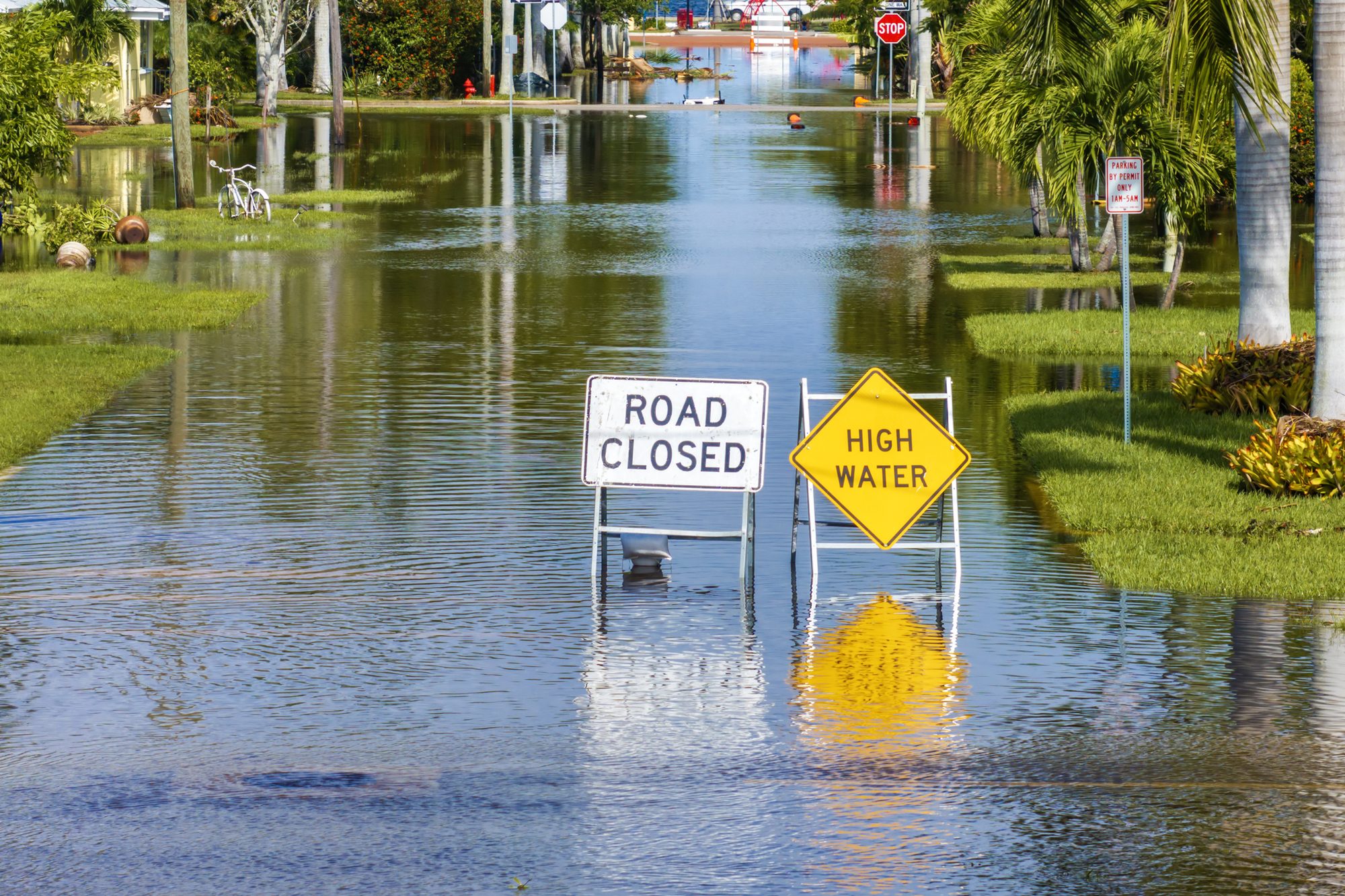 Hurricane Milton aftermath in Punta Gorda, Florida. City street closed because of flooding with warning signs blocking driving of cars