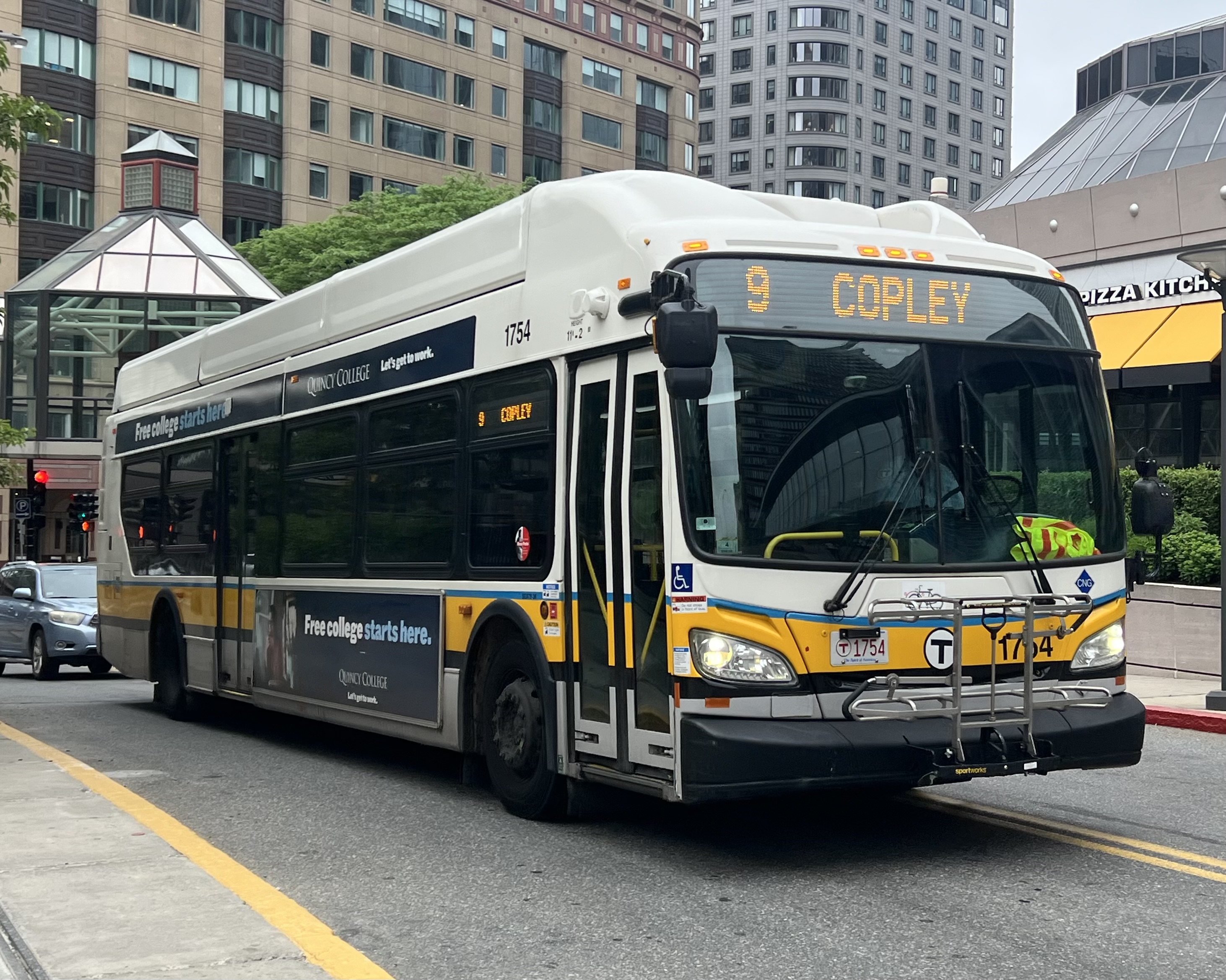 An MBTA bus with route 9 destination sign on a city street.