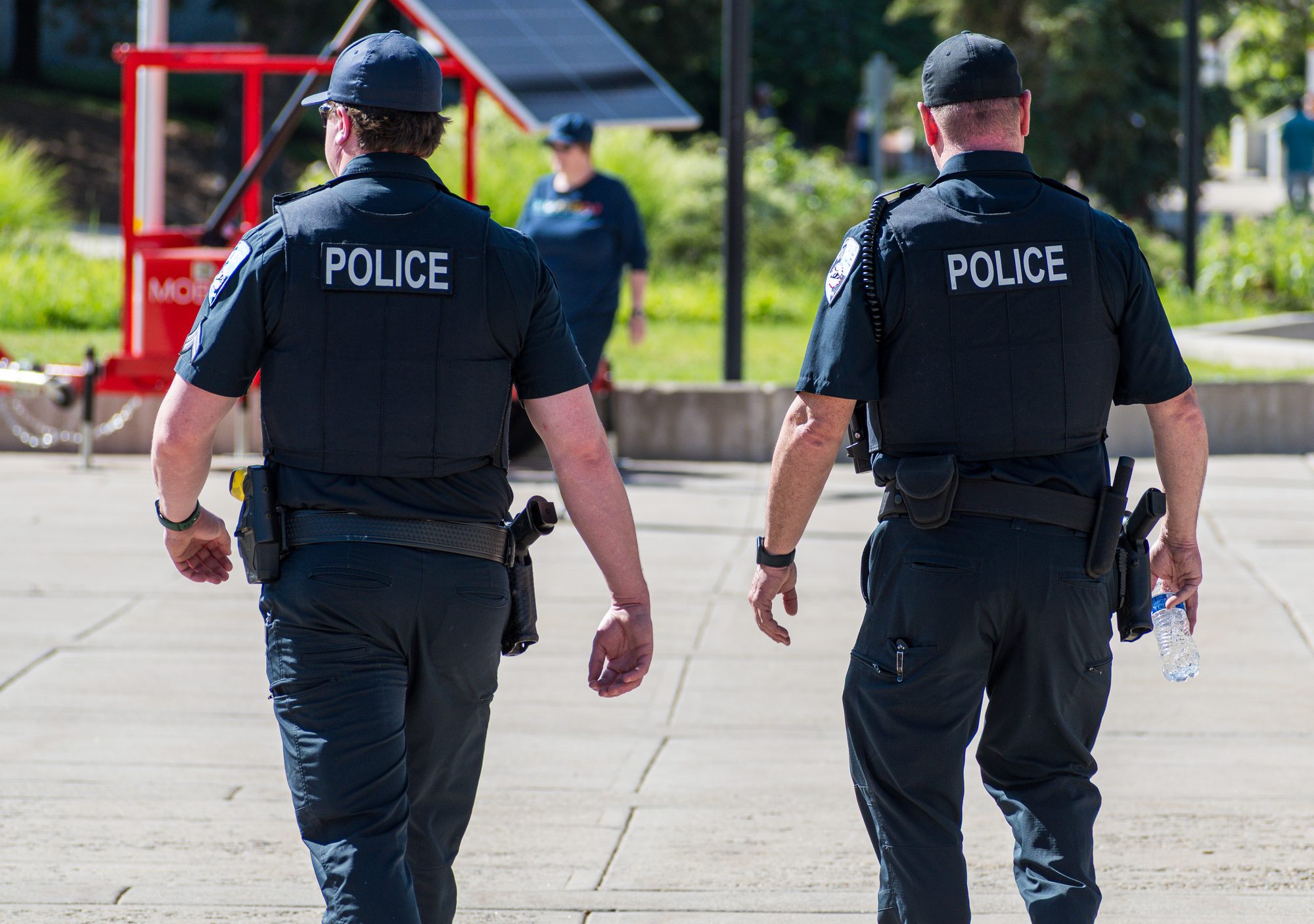 Police Officers Walking Through City Park – Salt Lake City