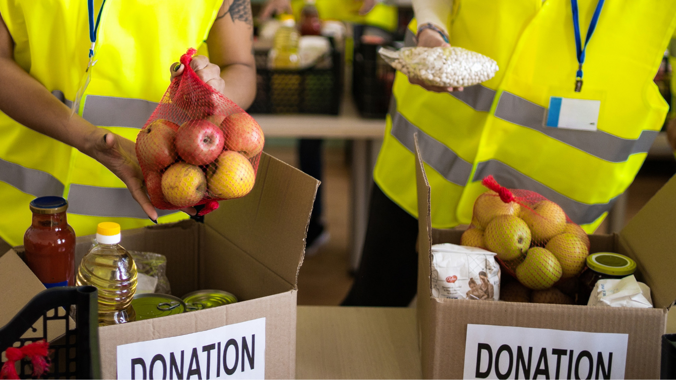 volunteers helping pack food donations
