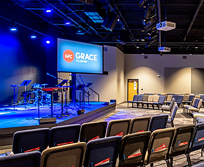 interior of church building with chairs and video screen
