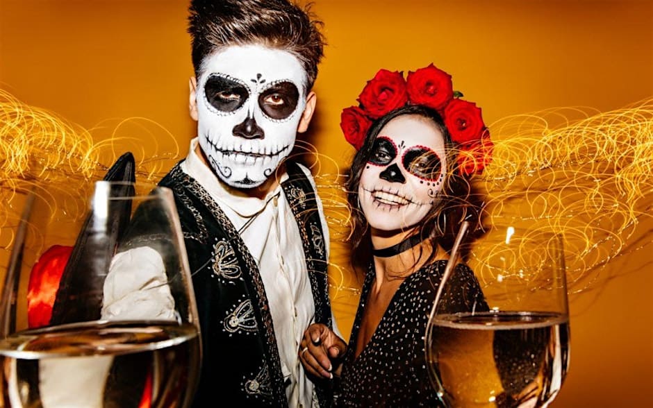 Promotional image of costumed adults holding wine glasses.