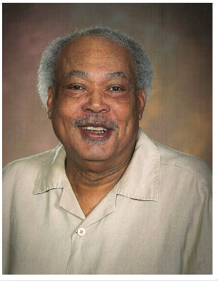 Portrait of Joseph Graves Jr. wearing a light-colored collared shirt.