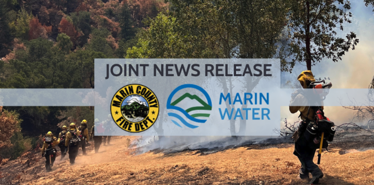Marin County firefighters walk through a smoky prescribed burn area beneath a joint Marin County Fire Department and Marin Water news release graphic.