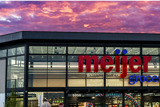 Exterior of the new Meijer supercenter in Plymouth Township at dusk, with the illuminated Meijer sign over the entrance.