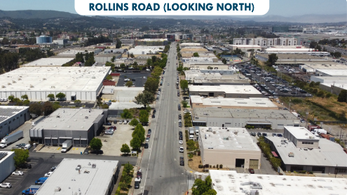 Aerial view of Rollins Road in Burlingame looking north, showing industrial buildings and warehouses along the corridor