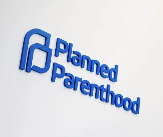 Planned Parenthood logo displayed on an office wall.