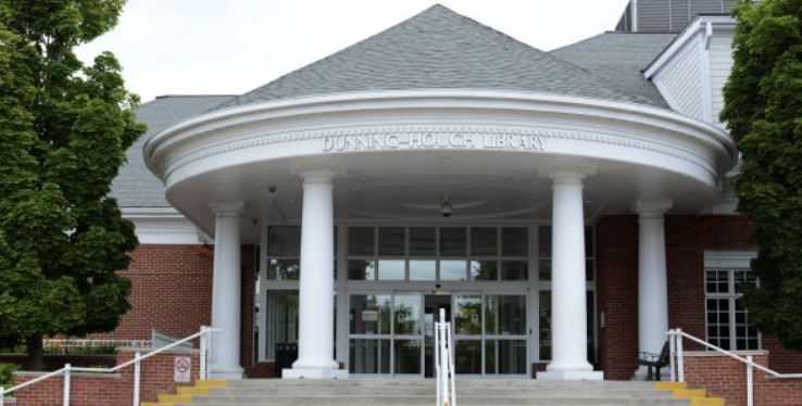 Exterior entrance of the Plymouth District Library, with white columns beneath a rounded portico.