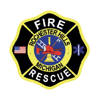Rochester Hills Fire Rescue department badge: a black and yellow Maltese cross with a red firefighter's helmet, ladder, axe, and pike pole at center, flanked by a U.S. flag and a blue Star of Life, with 'Fire Rescue' and 'Rochester Hills Michigan' lettered around the border.