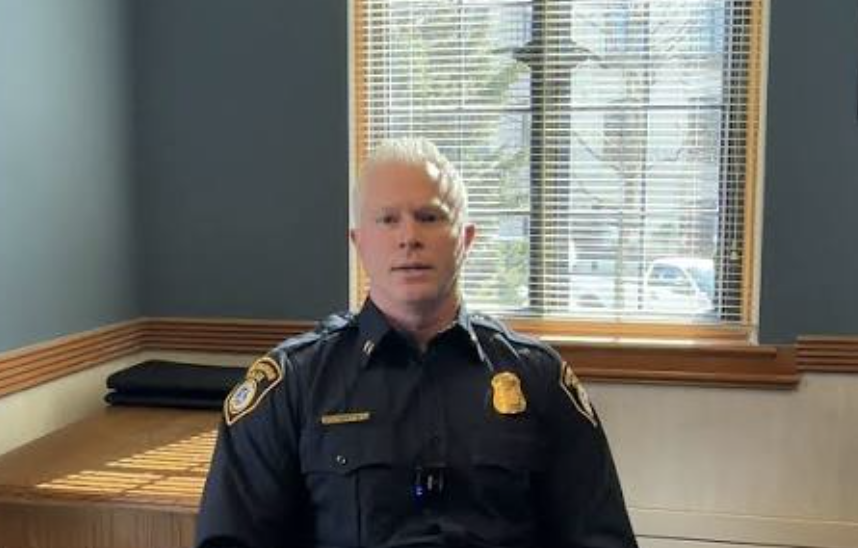 Birmingham Police Chief Ryan Kearney, in uniform, speaks during a recorded video message from a city office.
