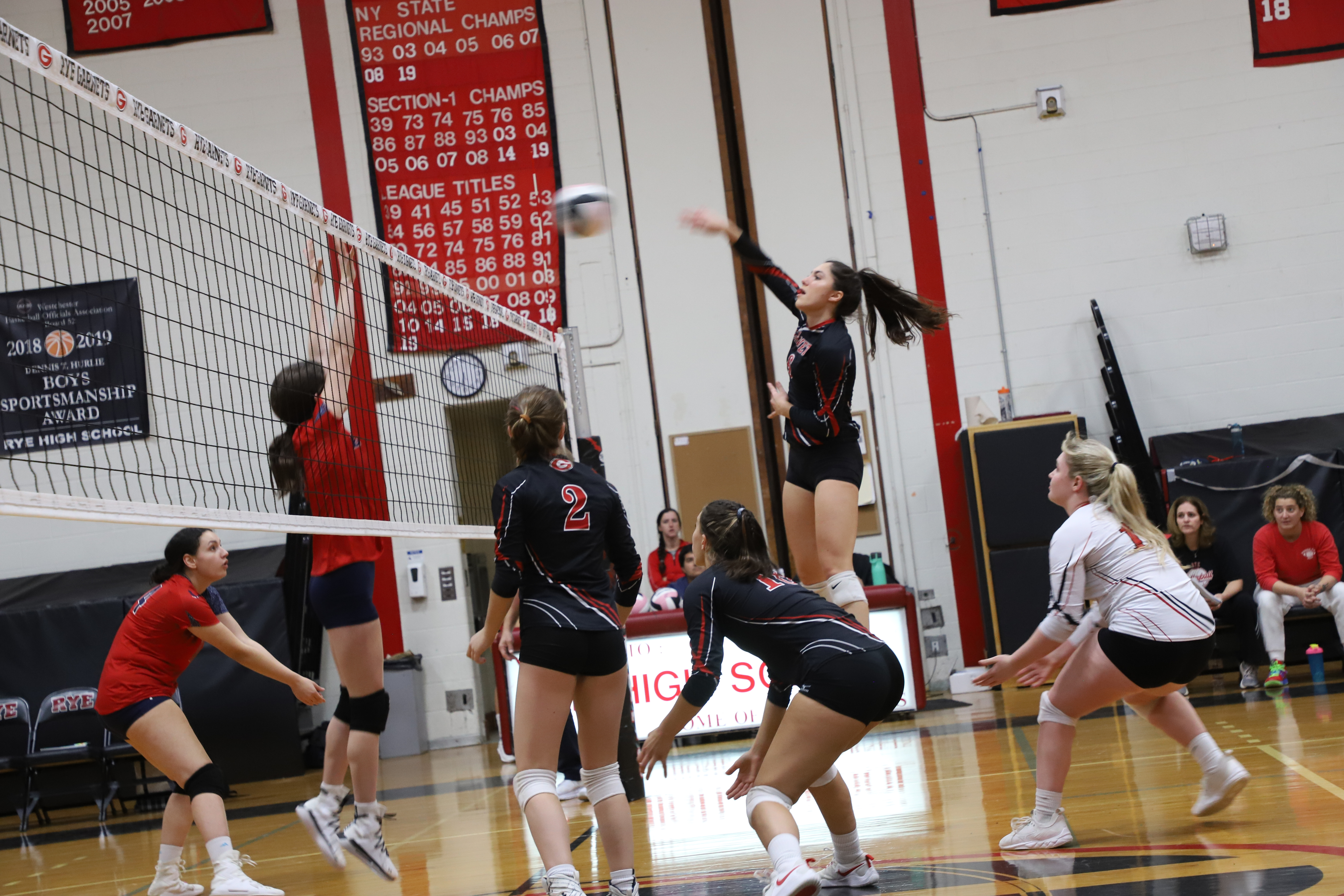 highschool girls playing volleyball match