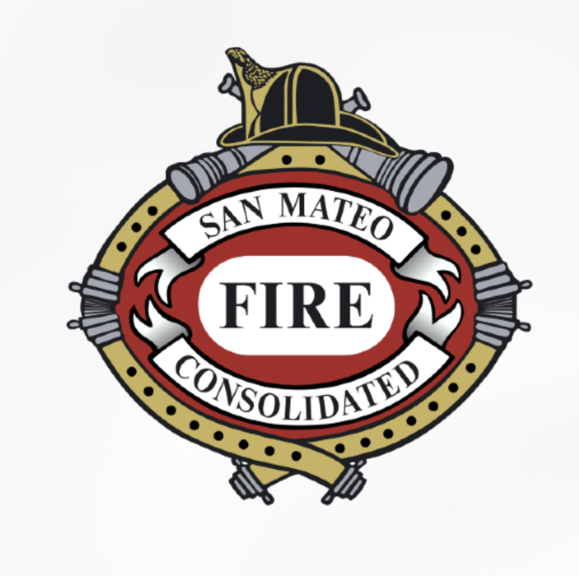 The official San Mateo Consolidated Fire Department logo, an oval crest with a firefighter's helmet, crossed hose nozzles and axes, reading "San Mateo Consolidated Fire" in red and gold.