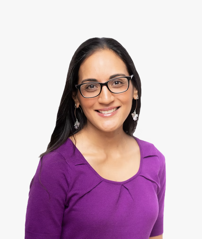 Seema Patel wearing glasses and a purple top against a white background.