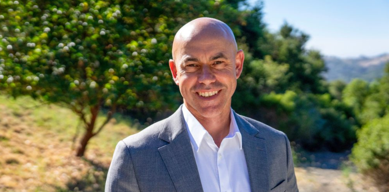 Portrait of Shaun Horne, Marin Municipal Water District's incoming general manager, standing outdoors with the Mt. Tamalpais watershed in the background.