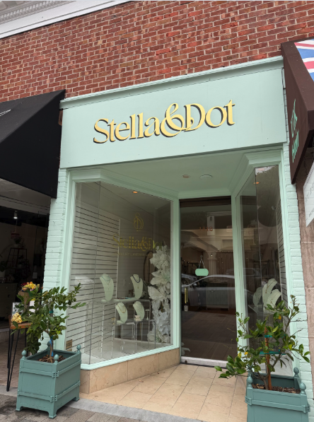 Exterior of the new Stella & Dot jewelry boutique at 1412 Burlingame Ave., with mint-green trim, gold signage, and potted plants flanking the entrance.