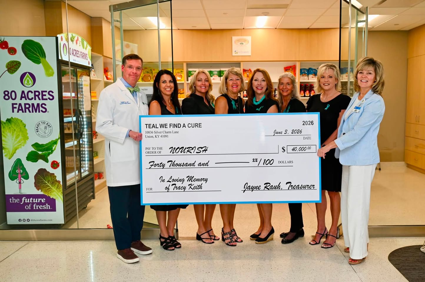 people posing with a giant check