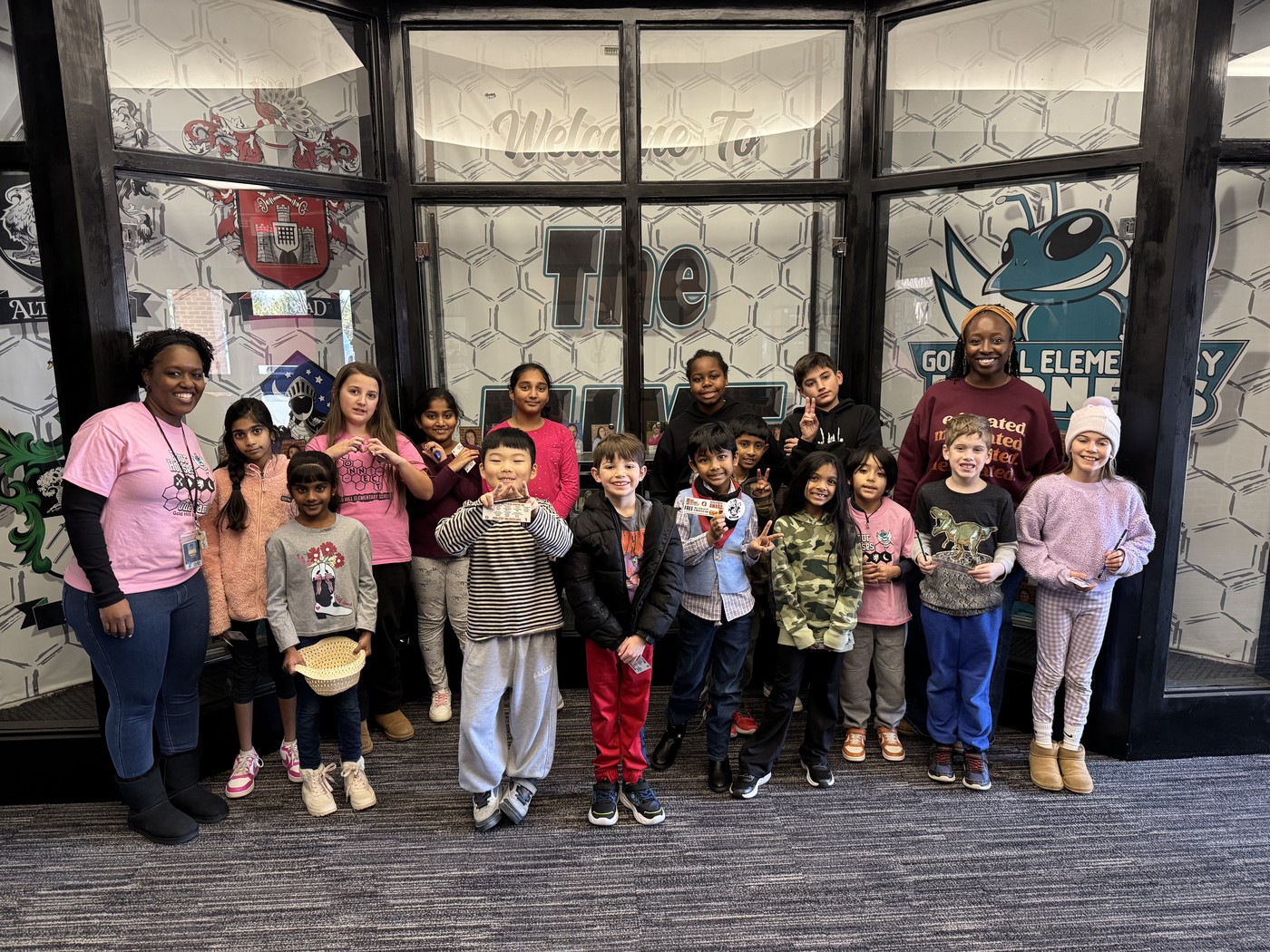 Gold Hill Elementary students and staff pose outside the school entrance with House Ticket awards.