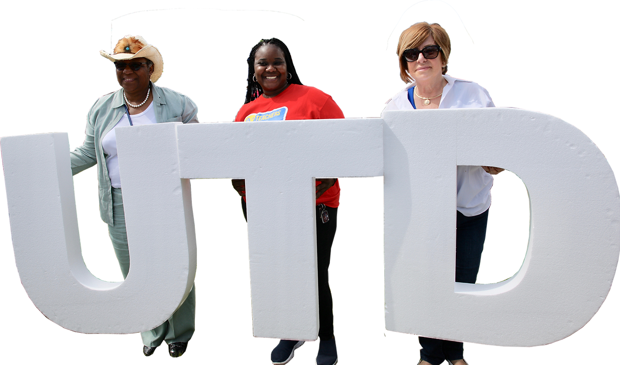 Three people stand behind large white UTD letters in a photo from United Teachers of Dade.