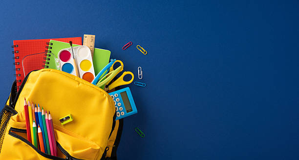 Yellow backpack filled with colorful school supplies and art materials for back to school creativity